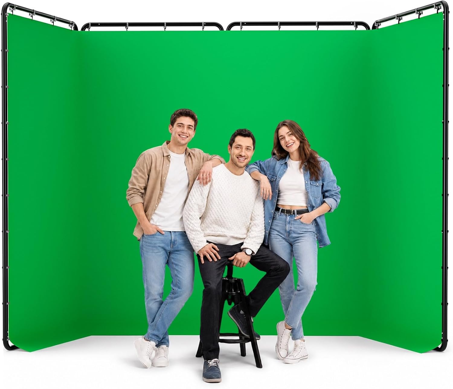 Three people posing in front of an EMART green screen with a four-panel black frame.