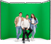 Three people posing in front of an EMART green screen with a four-panel black frame.