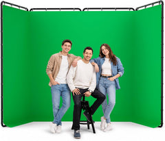 Three people posing in front of an EMART green screen with a four-panel black frame.