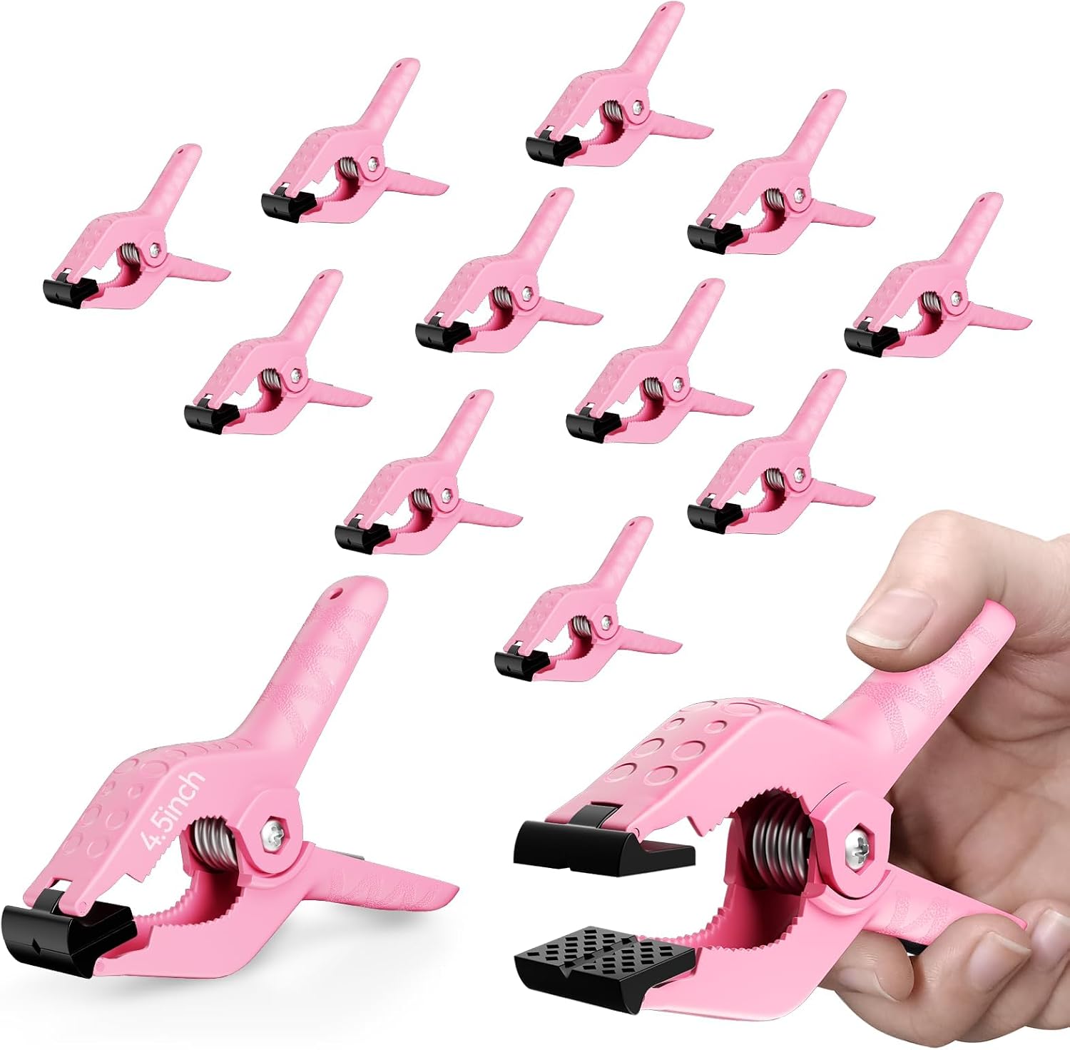 Set of pink spring clamps on a white background, with a hand opening one to show its black grip pads.