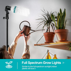 EMART spiral CFL bulb mounted on a stand beside potted indoor plants and a person holding a watering can.